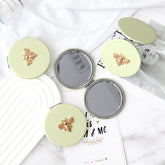 PU Eco-Friendly Leather With Metal Bee Decoration, Plating Silver Frame, And HD Glass Create A Fashionable Round Cosmetic Mirror With A Diameter Of 70mm, Making Your Makeup More Refined And Charming